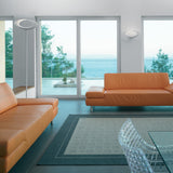 White Cabildo floor lamp illuminating a furnished interior with its sculptural oval ring shade.