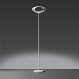 White Cabildo floor lamp with an illuminated oval ring shade, twin slender supports and a round base.